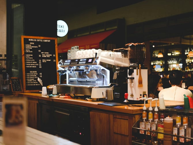 Lattes, bagels and empanadas on a cafe counter