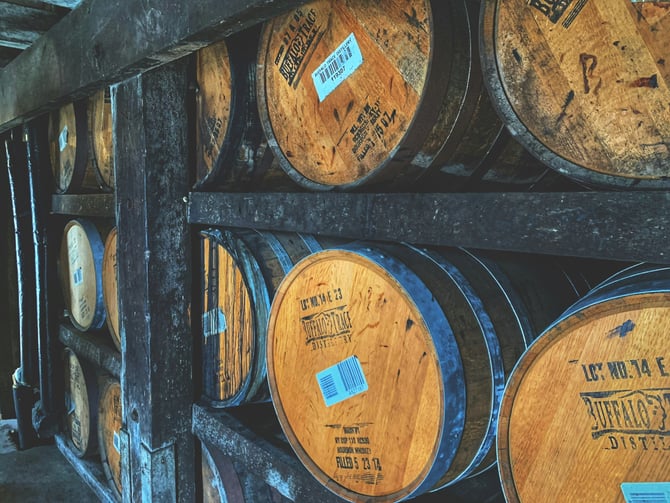 Guests boarding a private tour van outside a Louisville distillery